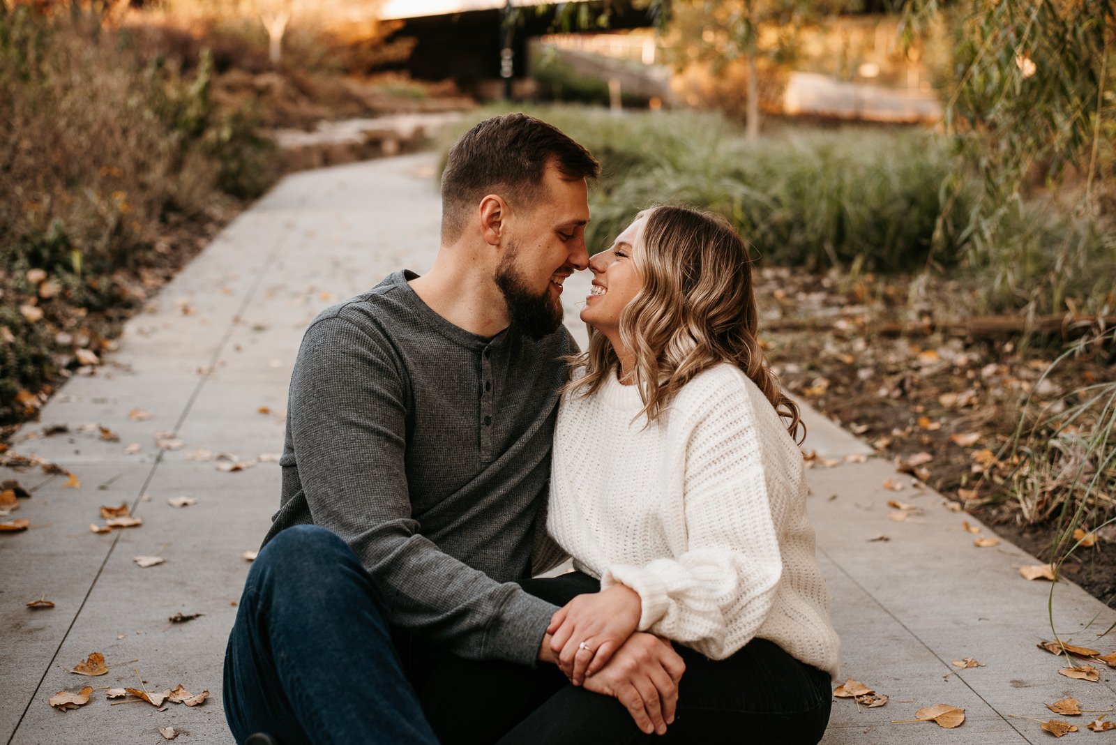 Indiana fall engagement session is a downtown Fort Wayne park with a cute couple cuddled up